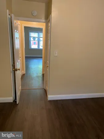 an empty room with wooden floor and a window