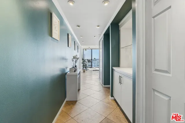 a view of entryway and hall with a front door