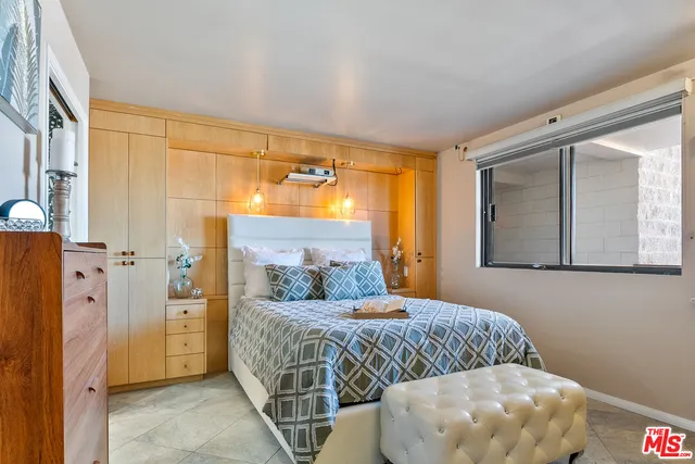 a bedroom with double bed and a window