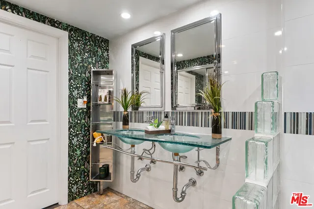 a room with furniture a large window and a potted plant