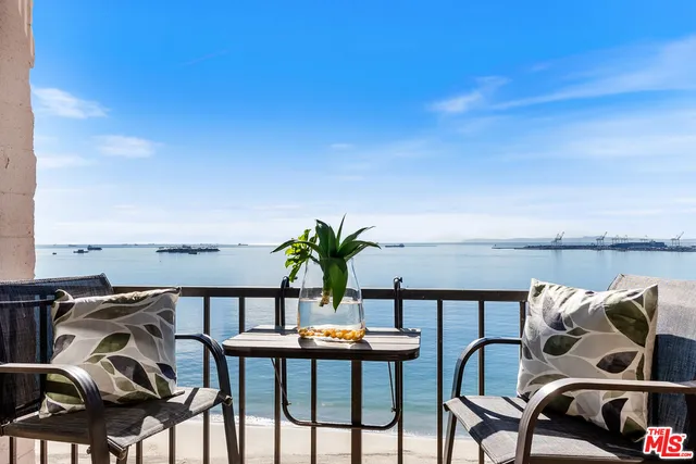 a balcony with furniture and umbrella