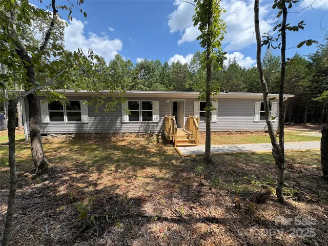 a view of a house with backyard porch and sitting area