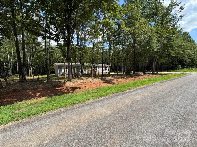 a view of park with trees and grass