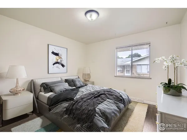 a bedroom with a bed and a painting on the wall