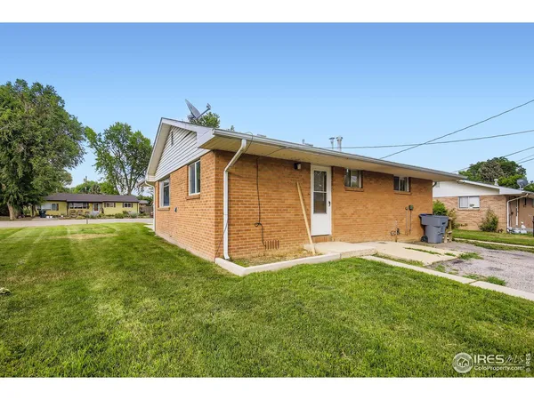 a backyard of a house with table and chairs