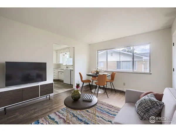 a living room with furniture a window and a flat screen tv