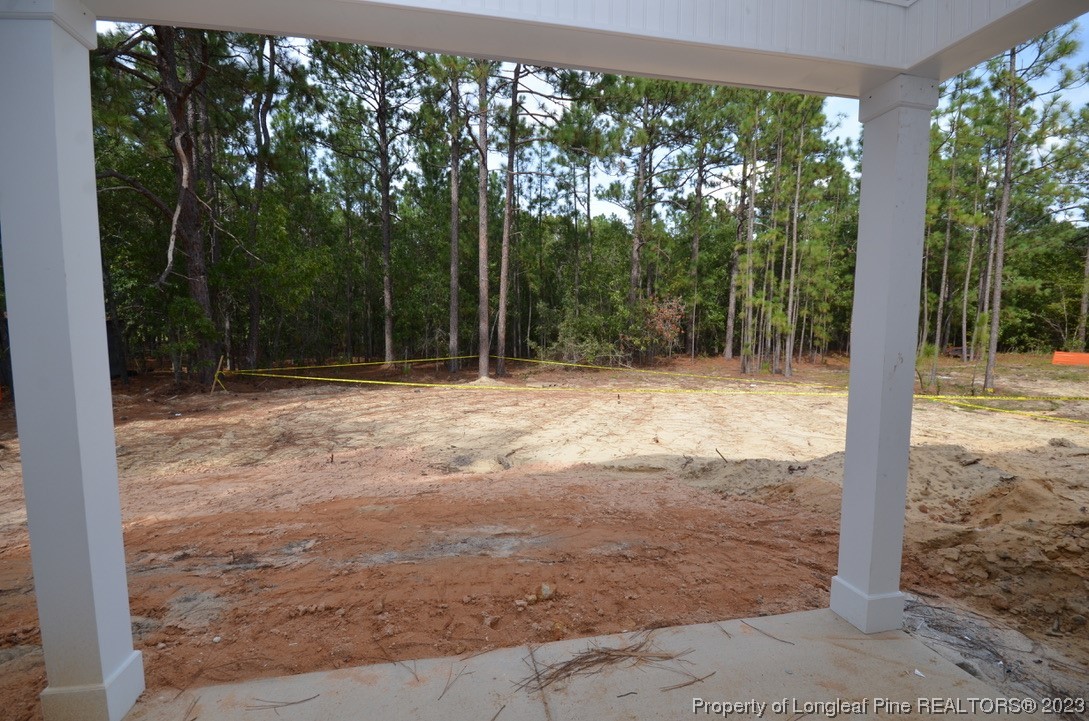 822 Quewhiffle Road Aberdeen, NC 28315 - Photo 6 of 7 a backyard of a house with lots of green space and fountain