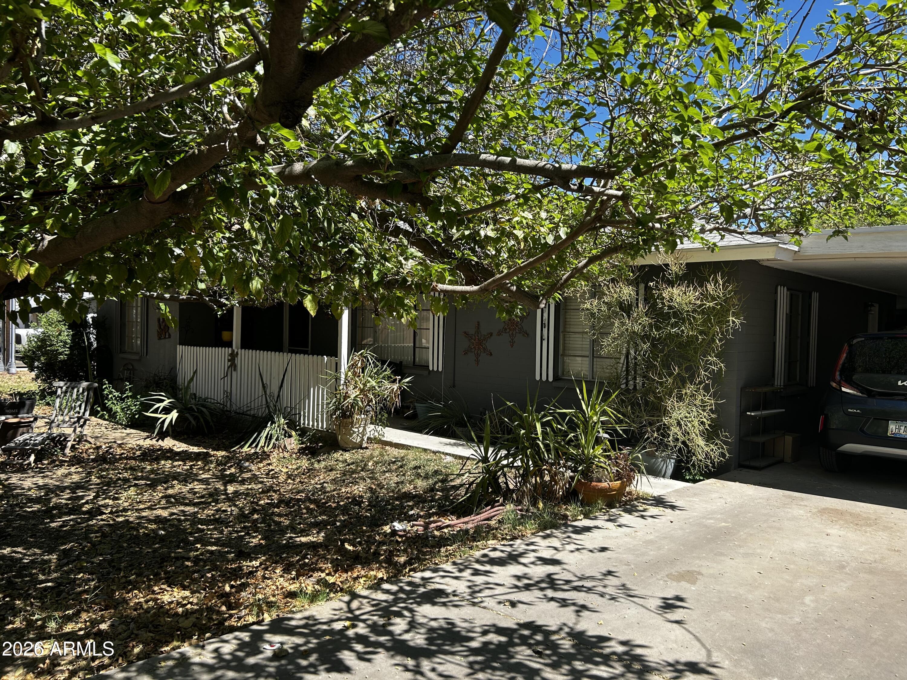 5625 South 9th Street Phoenix, AZ 85040 - Photo 1 of 8 a view of a tree in front of a house