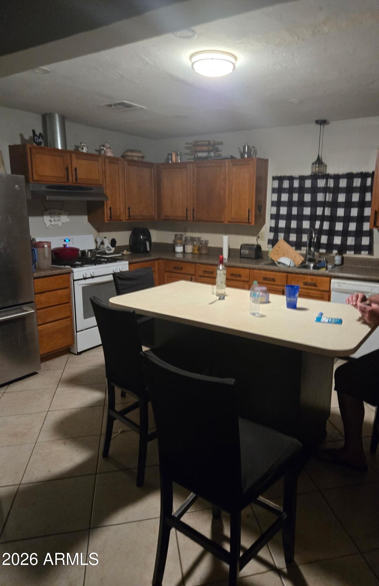 5625 South 9th Street Phoenix, AZ 85040 - Photo 6 of 8 a kitchen with a sink and chairs