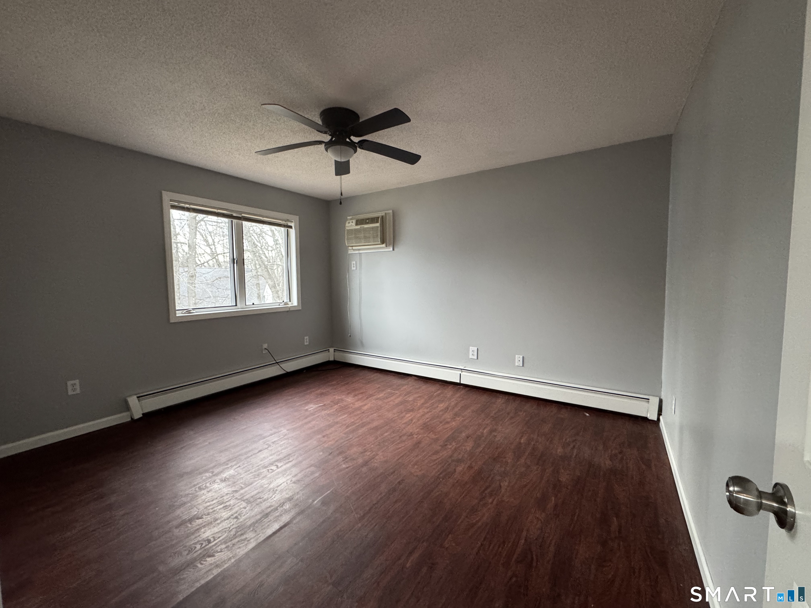 27 Katie Lane Waterbury, CT 06708 - Photo 9 of 14 a view of an empty room with wooden floor and a window