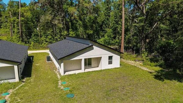 an aerial view of residential house with outdoor space