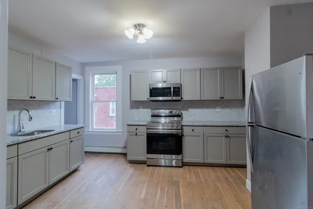 a kitchen with a sink stainless steel appliances and cabinets