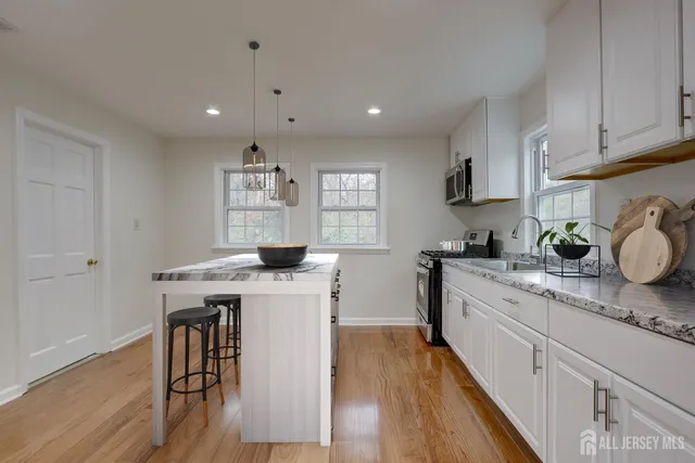 a view of room with window and wooden floor