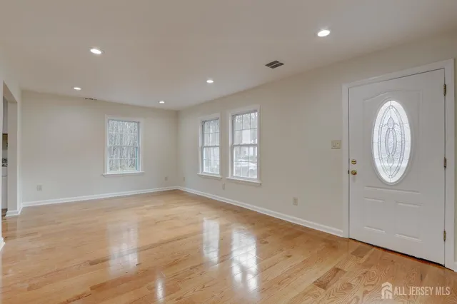 a view of a house with a yard covered with snow