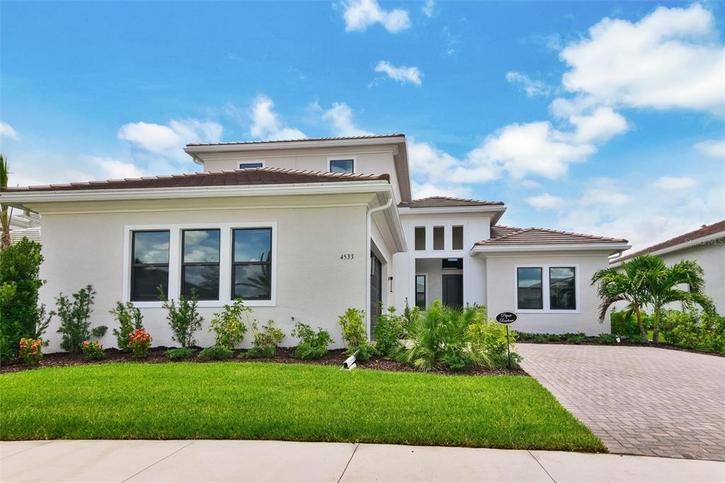 4533 Mondrian Court Sarasota, FL 34240 - Photo 1 of 49 a front view of a house with a garden