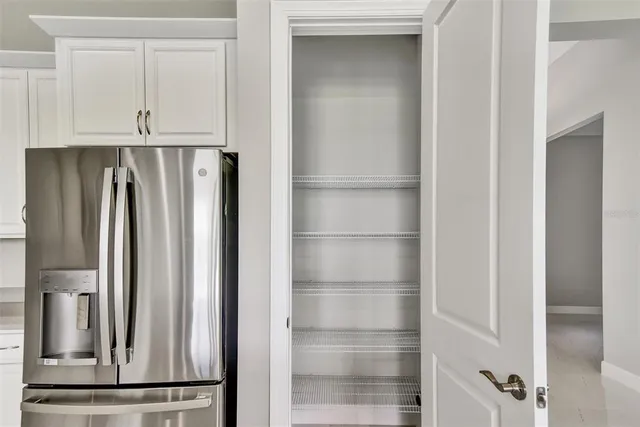 a view of walk in closet with cabinets