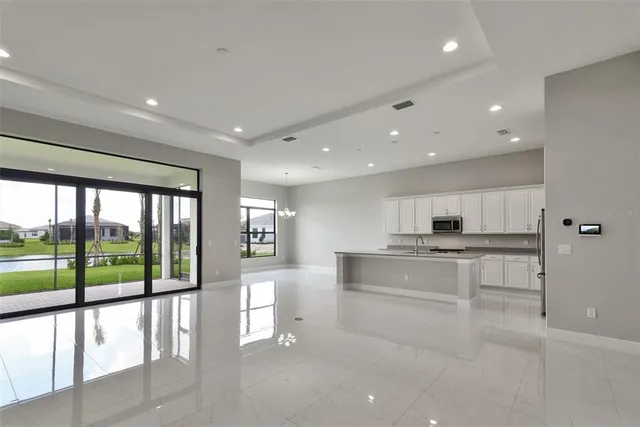 a large white kitchen with a large window