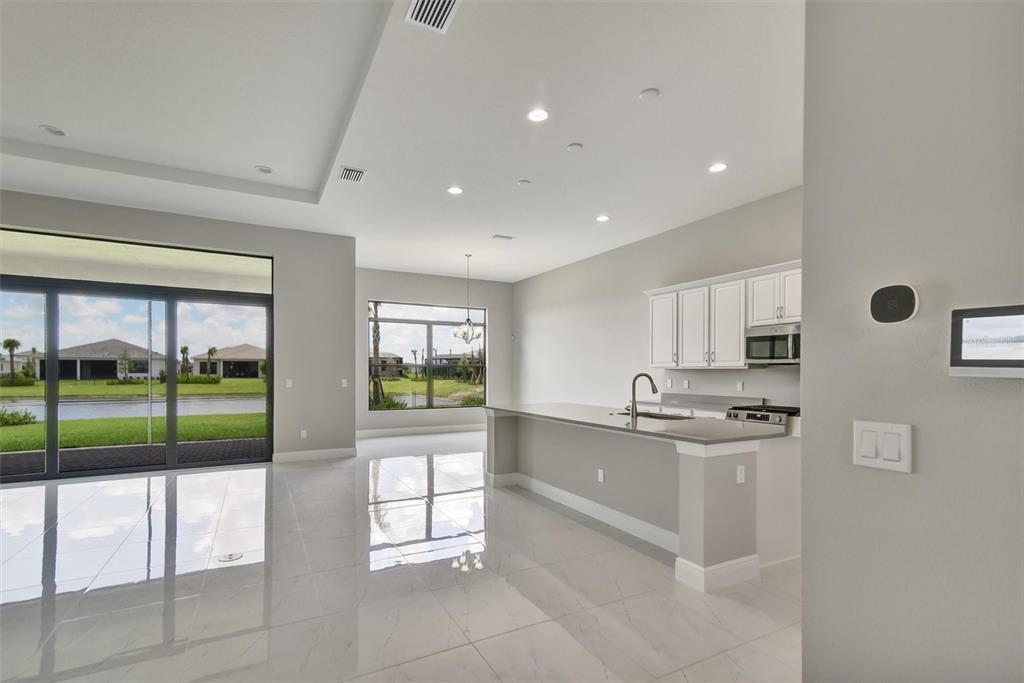 4533 Mondrian Court Sarasota, FL 34240 - Photo 13 of 49 a kitchen with stainless steel appliances granite countertop a sink and a stove top oven