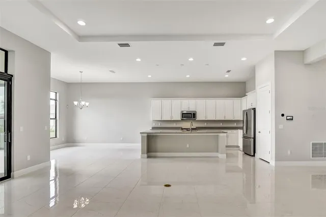 a kitchen with stainless steel appliances a stove a sink and a refrigerator