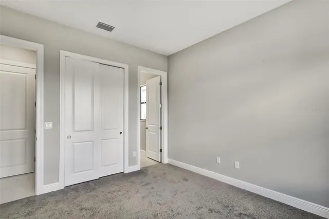 an empty room with closet area