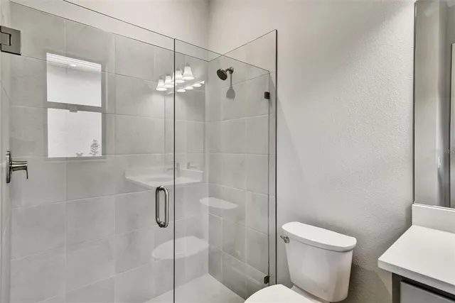 a bathroom with a toilet and shower