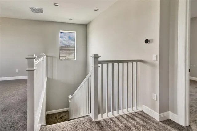 a view of a hallway with windows