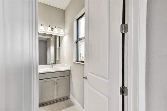 a en suite bathroom with a sink mirror and vanity