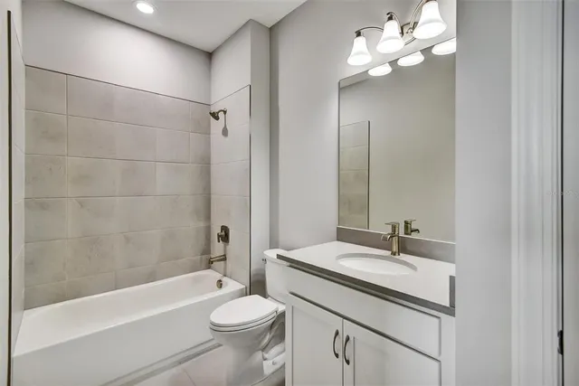 a bathroom with a sink a toilet and bathtub