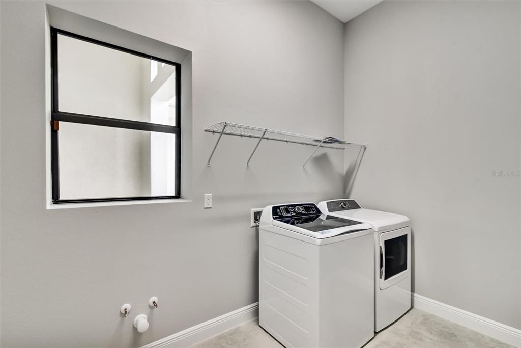 4533 Mondrian Court Sarasota, FL 34240 - Photo 41 of 49 a utility room with dryer and washer