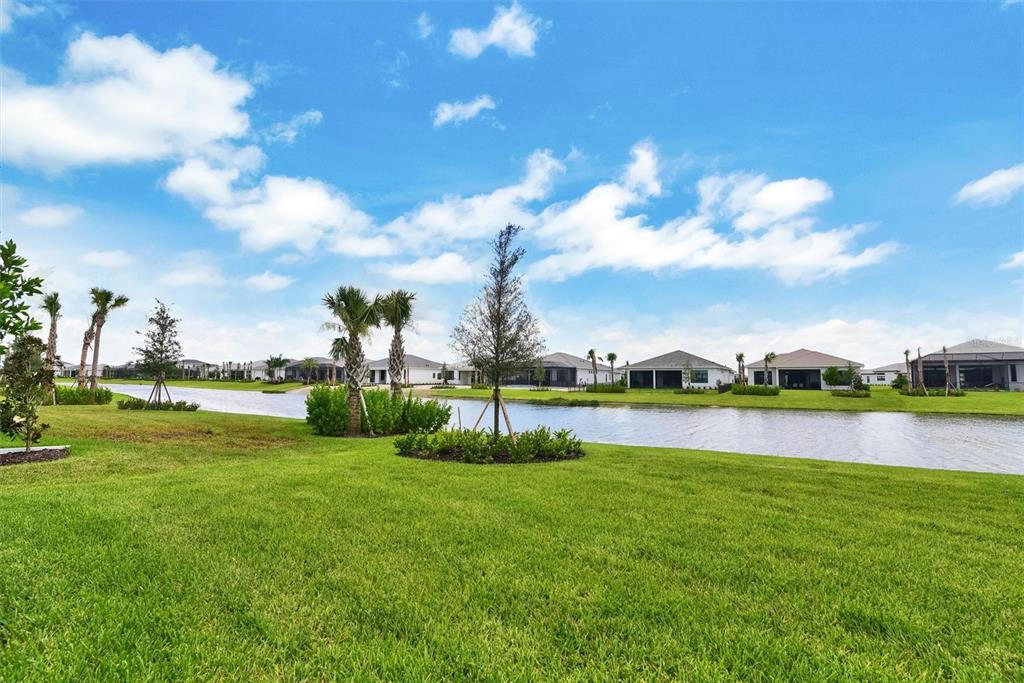 4533 Mondrian Court Sarasota, FL 34240 - Photo 44 of 49 a view of a lake with houses in the back