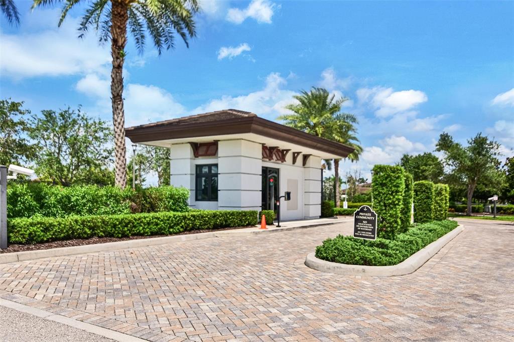 4533 Mondrian Court Sarasota, FL 34240 - Photo 45 of 49 a front view of a house with a yard and potted plants