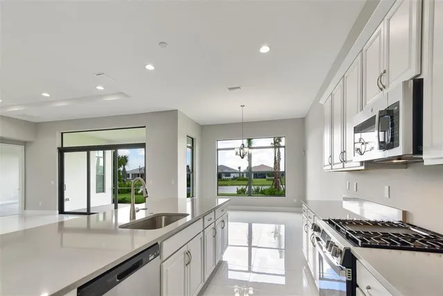a kitchen with stainless steel appliances granite countertop a stove and a sink