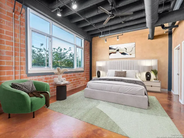 a spacious bedroom with a bed and a couch