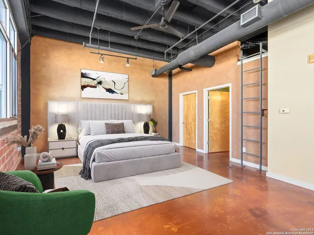 a spacious bedroom with a bed and a window