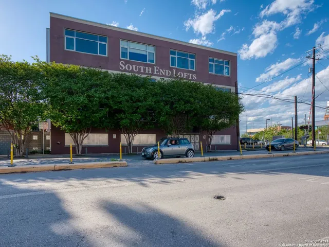 a view of a brick building next to a road