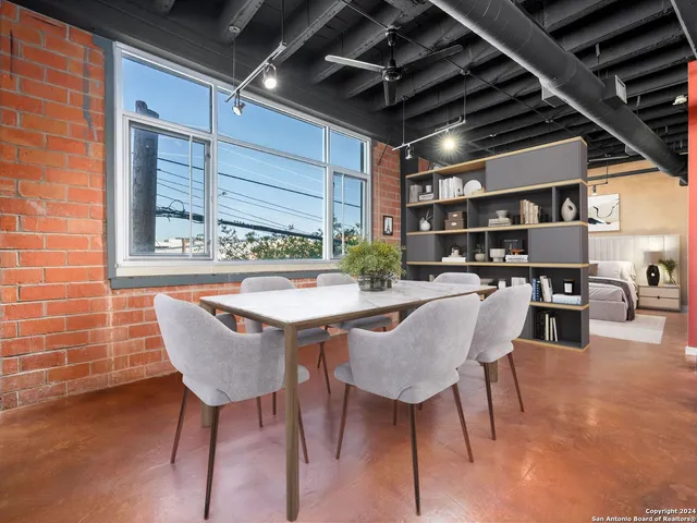 a dining room with furniture and a chandelier