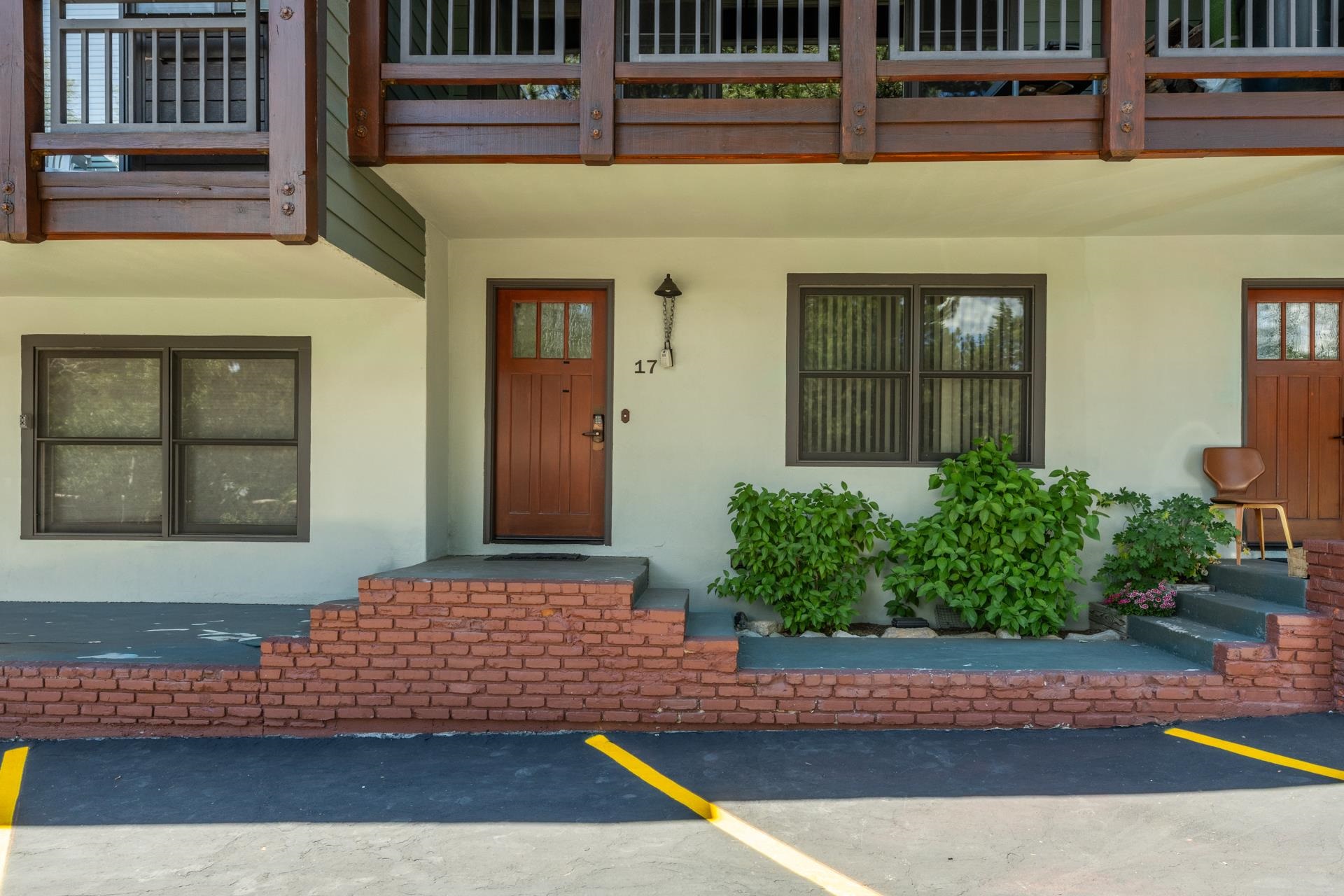 50 Hidden Valley Road, Unit 17 Mammoth Lakes, CA 93546 - Photo 2 of 40 Entryway featuring a Craftsman-style door with glass panels, brick foundation detailing, and an exte