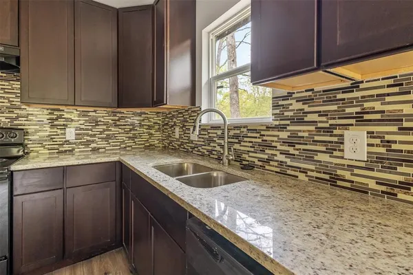 a kitchen with sink and cabinets