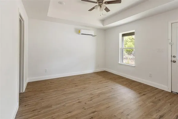 wooden floor in an empty room with a window