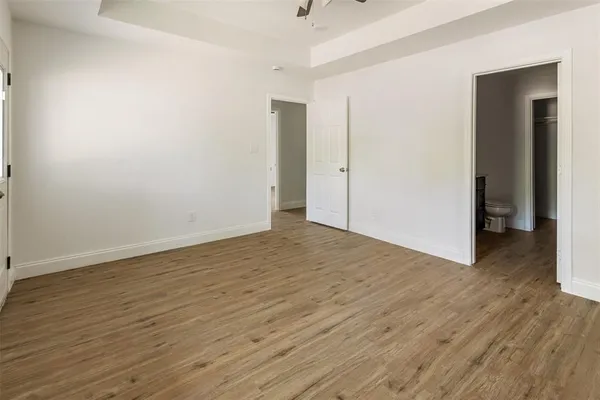 a view of an empty room with wooden floor