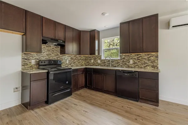 a kitchen with stainless steel appliances granite countertop wooden cabinets and a counter top