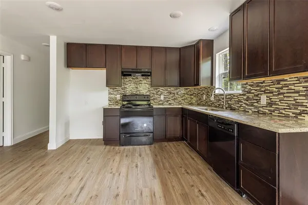 a kitchen with stainless steel appliances granite countertop a stove and a refrigerator