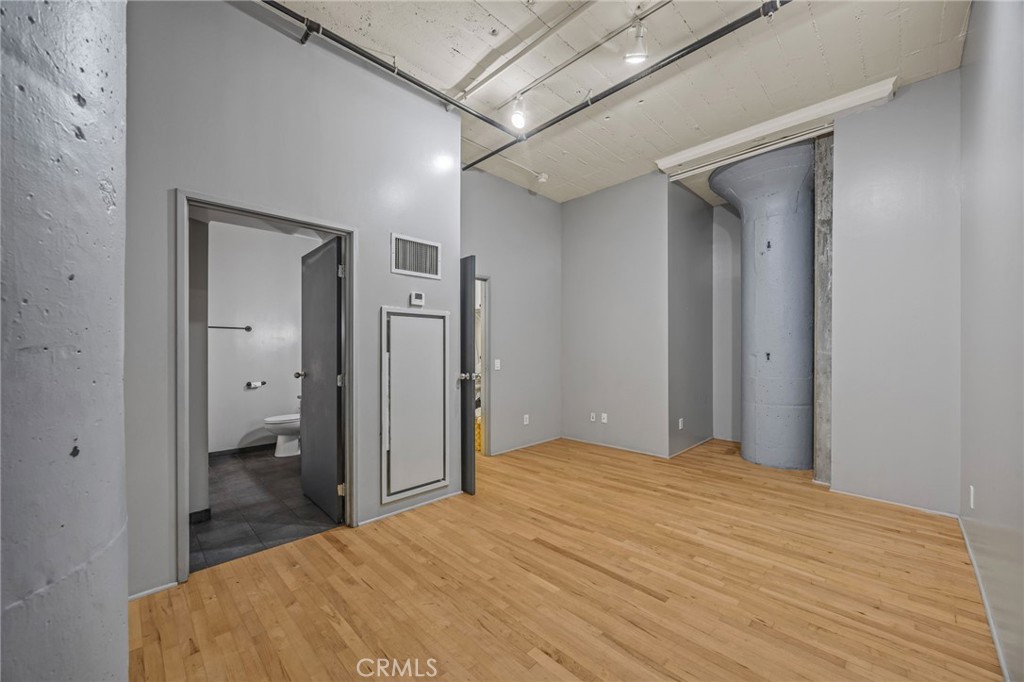 420 San Pedro Street, Unit 218 Los Angeles, CA 90013 - Photo 11 of 27 a bedroom with a bed and closet