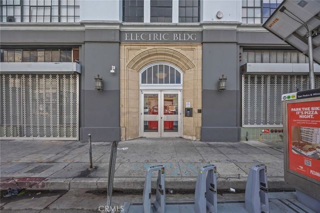 a view of a building with large window and table