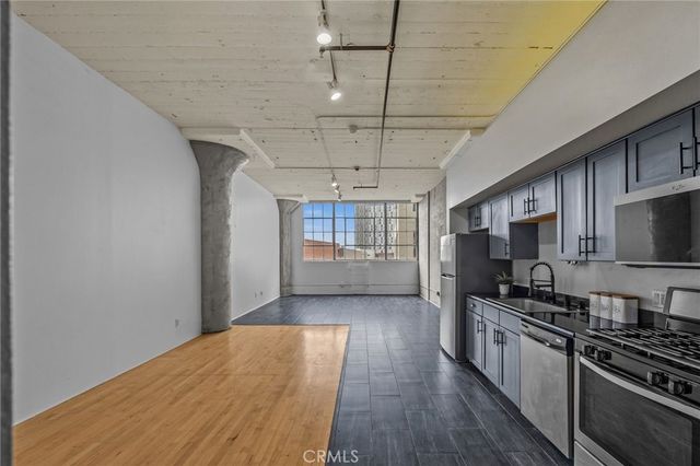 a kitchen with stainless steel appliances a refrigerator stove and microwave