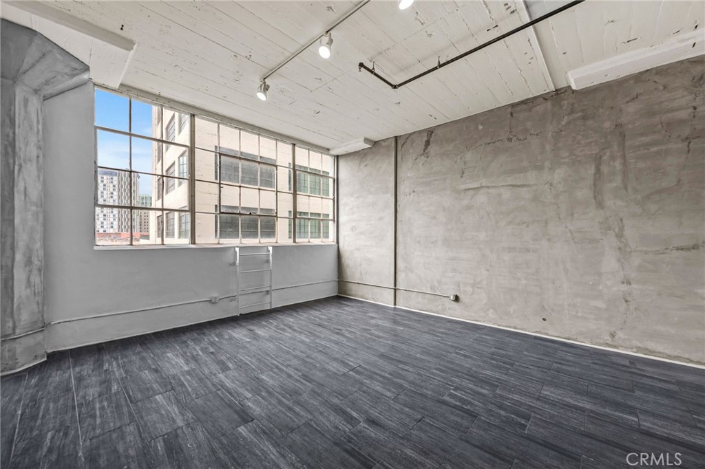 420 San Pedro Street, Unit 218 Los Angeles, CA 90013 - Photo 10 of 27 a view of an empty room with wooden floor and a window
