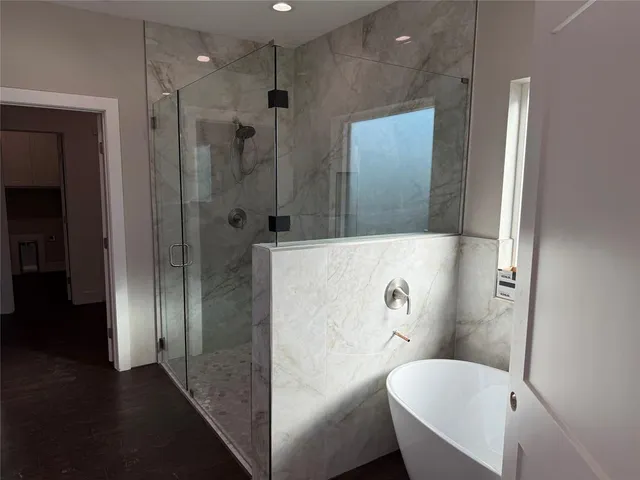 a bathroom with a granite countertop sink a mirror and shower