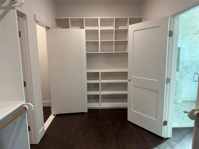 a view of closet with wooden floor