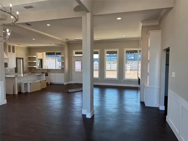 a view of a large kitchen with a sink and dishwasher with wooden floor
