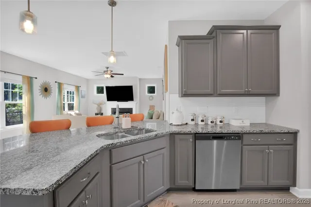 a kitchen with stainless steel appliances granite countertop a sink a stove and microwave
